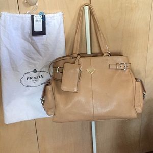 Prada Authenticate  leather bag w/ side pockets.
